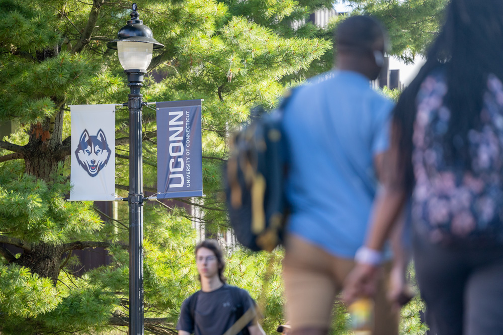 UConn students walk across campus on the first day of classes for the Fall 2023 semester